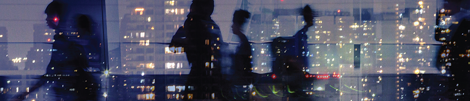 Reflection of people and cityscape on glass 