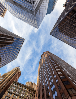 View of the sky looking straight up with skyscrapers surrounding.