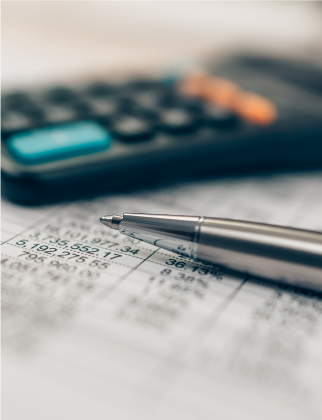 Close up of a calculator and a pen.